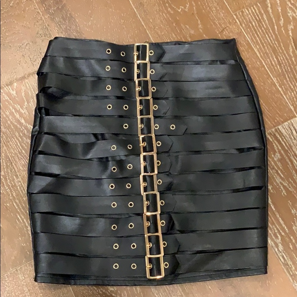Black leather skirt with gold buckles
